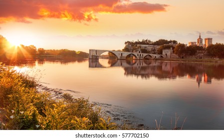 Avignon old bridge against colorful sunset in Provence, France