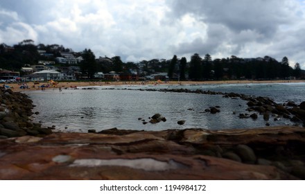 Avoca beach on a cloudy day in Autumn time. People can enjoy swimming, surfing, sunbathing and relaxing at Avoca beach. 