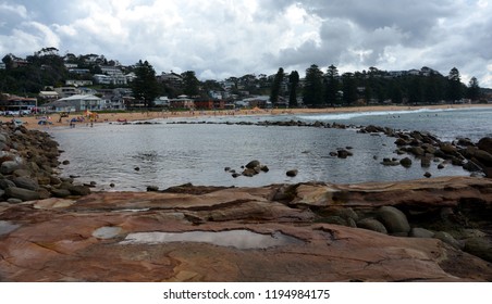 Avoca beach on a cloudy day in Autumn time. People can enjoy swimming, surfing, sunbathing and relaxing at Avoca beach. 