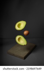 Avocado In The Air Rustic Wooden Table. Raw Fruits With Healthy Green Food. Concept Fruit Flying Split, No People