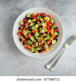 Avocado, Black  Bean, Corn And Bell Pepper Salad In White Bowl. Top View, Square Image