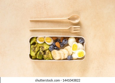 Avocado, boiled quail eggs with banana, blueberry and almond on marble background. Ketogenic diet. Low carb high fat breakfast. Healthy food concept