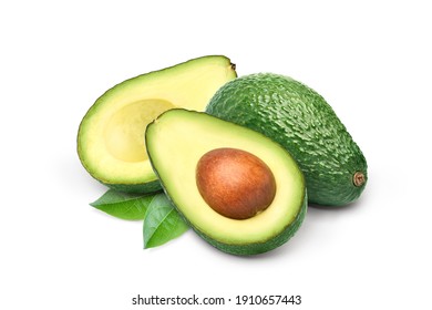 Avocado with cut in half and green leaves isolated on white background.