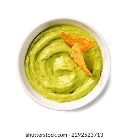 Avocado dip sauce guacamole with tortilla corn nachos chips in a white bowl . Isolated on white background. Top view.