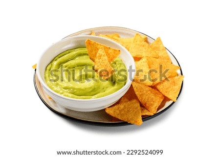 Avocado dip sauce guacamole with tortilla corn nachos chips in a white bowl . Isolated on white background.