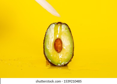 Avocado and feather on yellow background. Masturbation. Woman orgasm. Sex. Passion