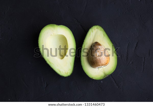 Avocado fruit on a black\
background