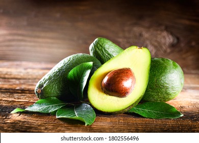 Avocado on rustic wooden table. Raw Fruits healthy green food concept. - Powered by Shutterstock