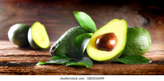 Avocado on rustic wooden table. Raw Fruits healthy green food. Avocados wide banner or panorama concept - Powered by Shutterstock