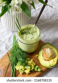 Avocado Ranch In A Jar With Dill Leaves, Chives, And Diced Avocado.