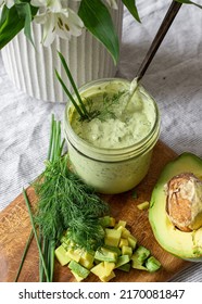 Avocado Ranch In A Jar With Dill Leaves, Chives, And Diced Avocado.