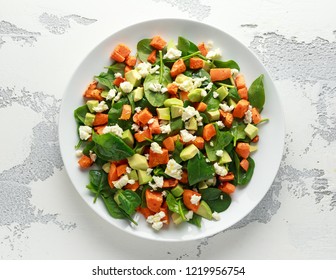 Avocado, Roasted Sweet Potato, Spinach, Feta Cheese Healthy Salad In White Plate.