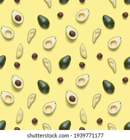 Avocado Seamless Pattern. Background Made From Isolated Avocado Pieces On Yellow Background. Flat Lay Of Whole And Half Avocados, Avacado Pieces And Seeds. 