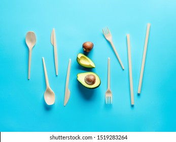 Avocado Seeds Biodegradable Single-Use Cutlery. Bioplastic - Great alternative to plastic disposable cutlery. Minimal concept on blue background.