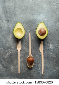 Avocado Seeds Biodegradable Single-Use Cutlery. Bioplastic - Great alternative to plastic disposable cutlery. Top view, flat lay. Copy space for text or design. Gray background. Vertical
