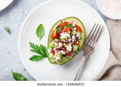 Avocado Stuffed With Tomato, Cucumber And Feta Cheese On White Plate, Top View,