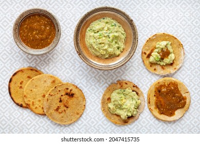 Avocado With Tahini And Greek Yogurt Sauce With Roasted Tomatillo Salsa On Corn Roti Flatbread.