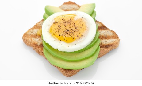 Avocado Toast With Fried Egg Isolated On White Background. Healthy Food Concept