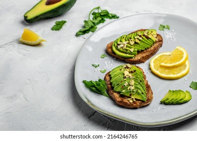 Avocado Toast. Healthy Toast With Avocado For Breakfast Or Lunch With Rye Bread. Clean Eating, Dieting, Vegan Food Concept. Top View.