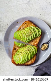 Avocado Toast With Hemp Seeds On A Gray Plate. Healthy Vegan Food Concept.