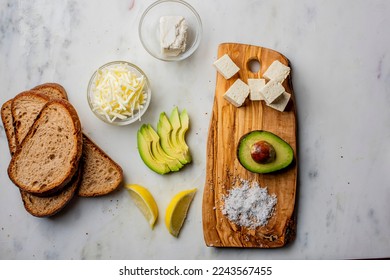 Avocado Toast. Open sandwich of toast with mashed avocado, tomatoes, eggs, cheese salt, black pepper, and citrus juice. Fresh avocados smashed into guacamole on toast with vegetables. Classic Lunch. - Shutterstock ID 2243567455