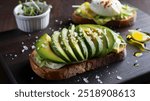 Avocado Toast: Thick slices of toasted bread topped with creamy mashed avocado, sprinkled with salt, pepper, and a squeeze of lemon.