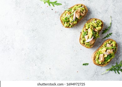 Avocado Toast With Tuna And Arugula, Overhead View. Food Background With Copy Space.