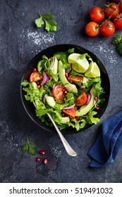 avocado, tomato and arugula salad. Healthy vegan food. Top view - Shutterstock ID 519491032