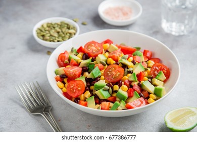 Avocado, Tomato, Black  Bean, Corn And Bell Pepper Salad In White Bowl.