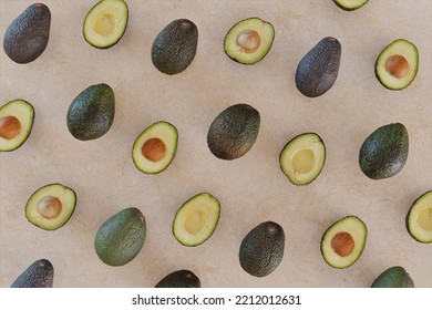 Avocados from above on a pink marble surface - Shutterstock ID 2212012631