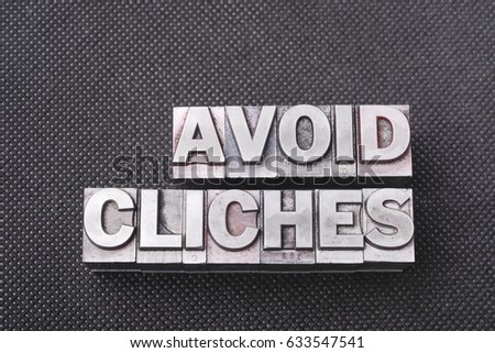avoid cliches phrase made from metallic letterpress blocks on black perforated surface