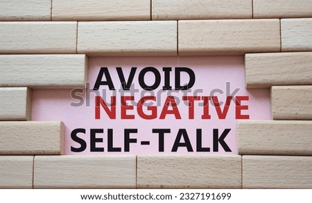 Avoid negative self-talk symbol. Concept words Avoid negative self-talk on wooden blocks. Beautiful pink background. Business and Avoid negative self-talk concept. Copy space.
