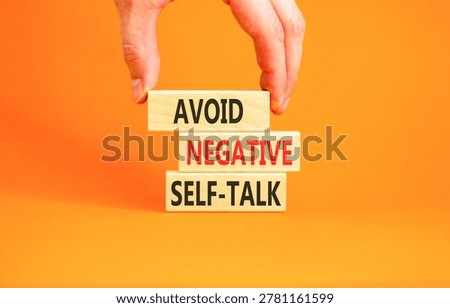 Avoid negative self-talk symbol. Concept words Avoid negative self-talk on beautiful wooden blocks. Beautiful orange background. Business psychology avoid negative self-talk concept. Copy space.