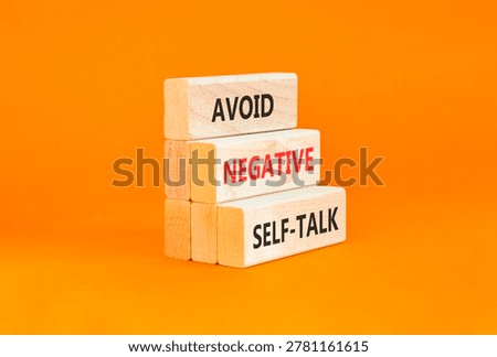 Avoid negative self-talk symbol. Concept words Avoid negative self-talk on beautiful wooden blocks. Beautiful orange background. Business psychology avoid negative self-talk concept. Copy space.