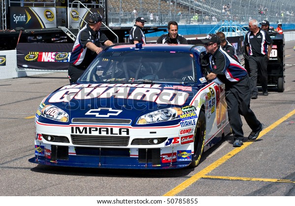 AVONDALE, AZ - APRIL 10: The pit crew pushes the #88\
National Guard car, driven by Dale Earnhardt Jr., onto the track\
before the start of the Subway Fresh Fit 600 on April 10, 2010 in\
Avondale, AZ.