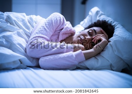 Awake African American Woman In Bed With Insomnia. Sleep Nightmare
