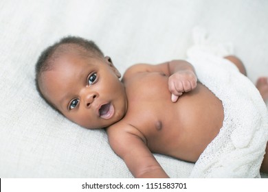 Awake Newborn Baby On Cream White Background