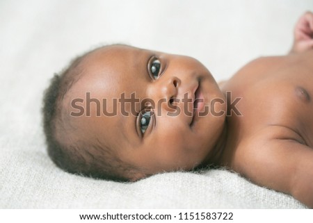 Awake Newborn Baby on Cream White Background