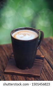 Awaken The Senses. Hot Latte Art Coffee On Wooden Table. Copy Space In Upper Part