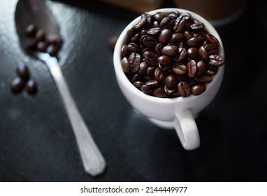 Awaken Your Senses. Studio Shot Of Coffee Beans In A Cup And On A Spoon.