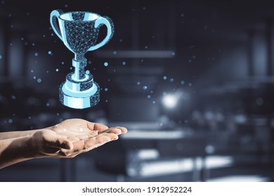 Award Concept With Polygonal Winner Trophy Cup Above Man Hand At Abstract Dark Background.