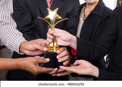 Award trophy winner business team with their success.