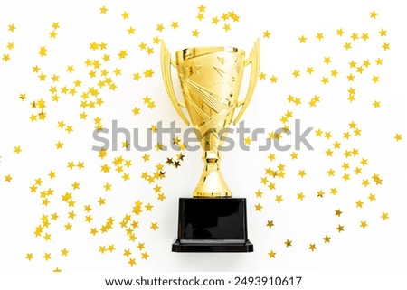 Award victory trophy cup with golden stars, top view. Success and victory concept.