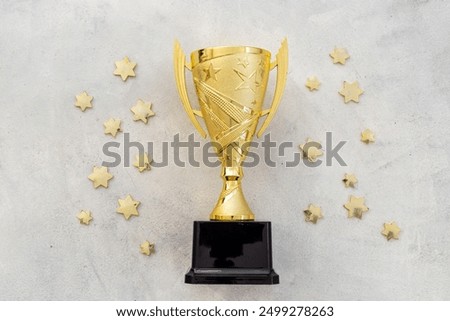 Award victory trophy cup with golden stars, top view. Success and victory concept.