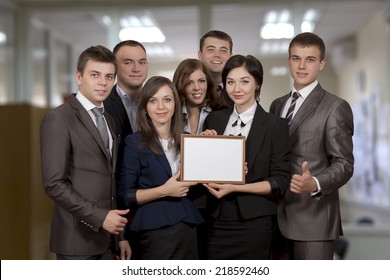 Awarded business team. Business team of seven members just received the award for achievement and expresses pride and happiness. The frame they keep is blank, you may easily insert any text you want. - Powered by Shutterstock