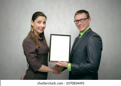 Awarding A Diploma Certificate To A Best Employee Or Student Mock Up. Winner Award Ceremony Concept. One Person Handing A Blank Diploma With Copy Space To Another Person. Best Worker Or Student.