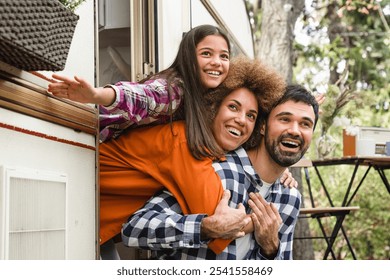 Away from everything concept. Mom dad and daughter family driving van home on wheels camper together. Adventure on caravanning. Road trip voyage with children kids - Powered by Shutterstock