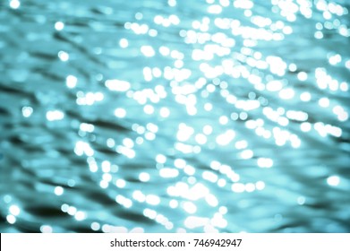 Awe beautiful vibrant cyan shallow moonlight night path of round highlights spot particles on wet misty backwater area. Close-up view with space for text on fresh blur spa pool. Spring travel scene - Powered by Shutterstock