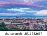 Awe cityscape of Lyon, France, at dusk with red clouds