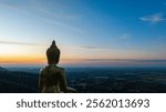 An awe-inspiring view of a big golden Buddha statue atop a hill overlooking a serene valley, captured during the vibrant colors of sunset. aerial view of The biggest golden Buddha at Lopburi Thailand